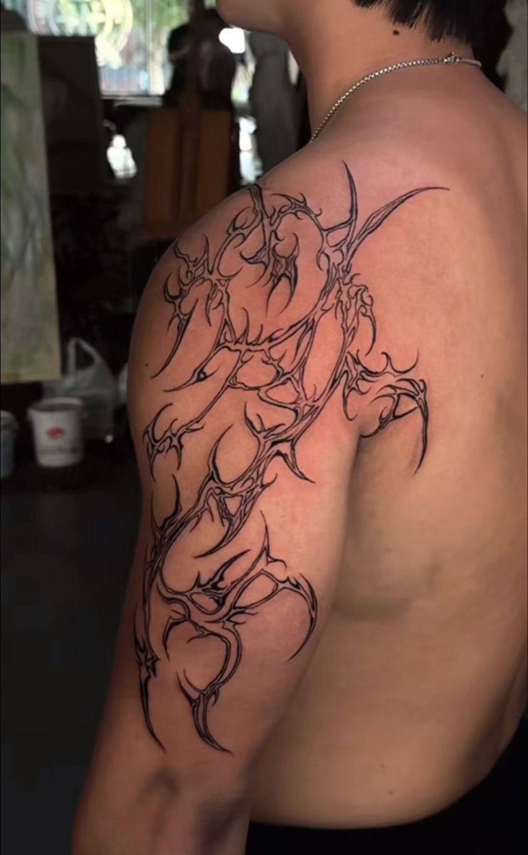 Neo-tribal biomechanical shoulder tattoo